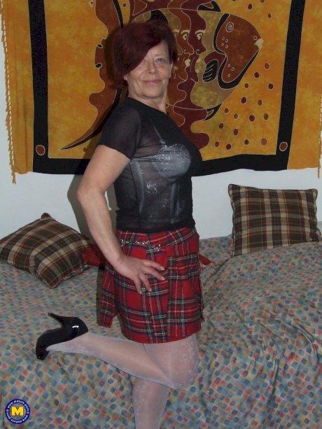 Chubby granny Rosie R masturbates with a toy wearing lacy white lingerie