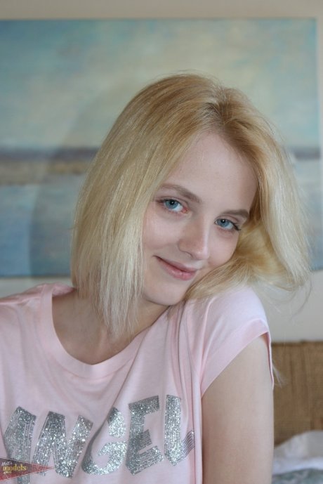 Petite blonde Kate Bloom parts her wet pussy after getting naked on her bed