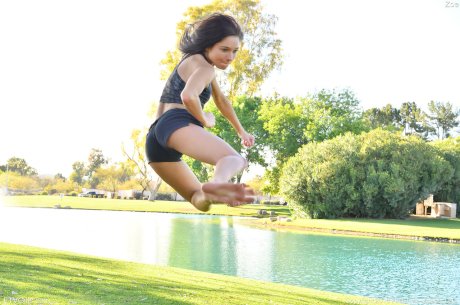 Teenage hottie in sexy outfit Zoe doing exercise outdoors by the water