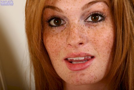 Pretty teen with freckled face taking off her lingerie and teasing her slit