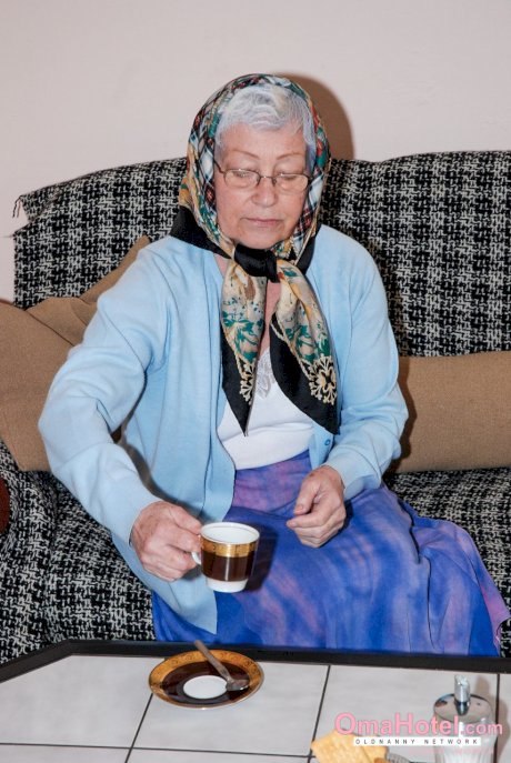 Cute granny with glasses Agnes strips and massages a nice fat dick