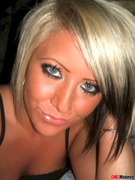 Blonde girl with striking eyes covers her naked body in chocolate sauce