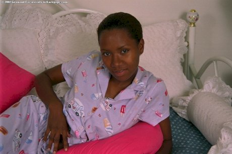 Teen ebony Dazy is lying naked and playing with nice big boobs