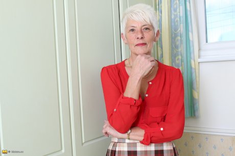 Over 70 Bristish granny takes off her clothes and lingerie striptease style