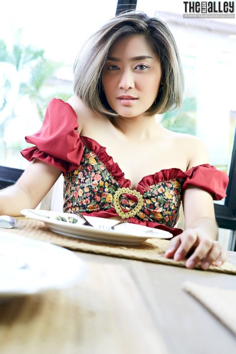 Asian solo girl Apple rubs her bush on a table after going topless