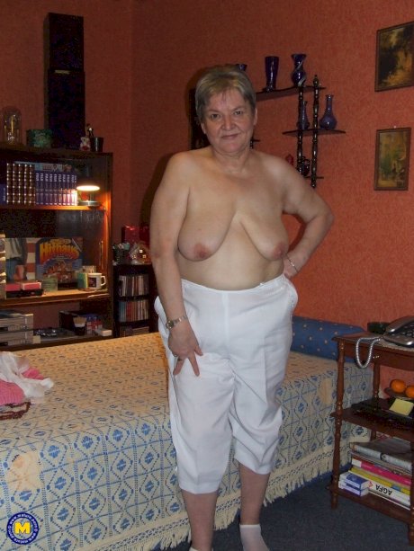 Fat granny Uschi doffs her clothes, poses naked and masturbates on a bed