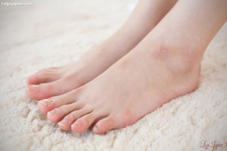 Young Asian Japanese girl in stockings undressing to suck her bare toes
