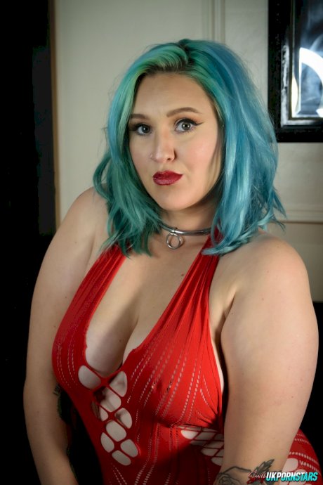 UK pornstar Ruby Fall lets her nipples slip free from a revealing red dress