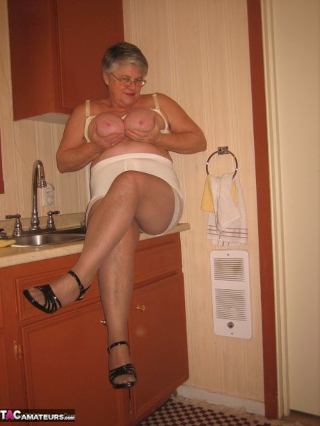 Old woman Girdle Goddess strips to pantyhose in her kitchen