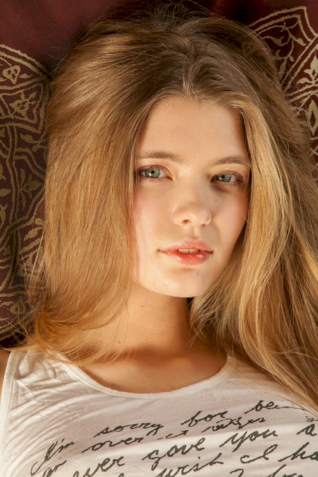 Blonde teen with a pretty face Sigrid gets completely naked atop her bed