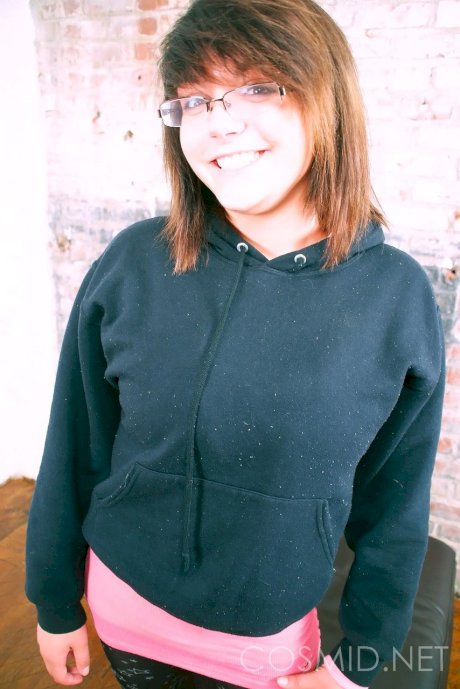 Cute brunette Morgan uncups her enhanced tits with her glasses on