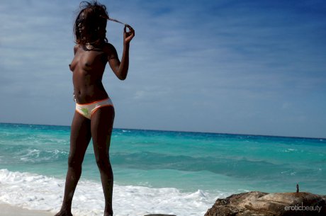 Ebony small tit babe Maria L gets naked at the beach and exposes her dark cunt