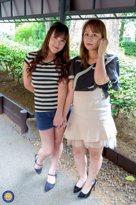 Japanese lesbians Kyoko Tachibana and Aki Sakura kiss before 69 sex on a sofa