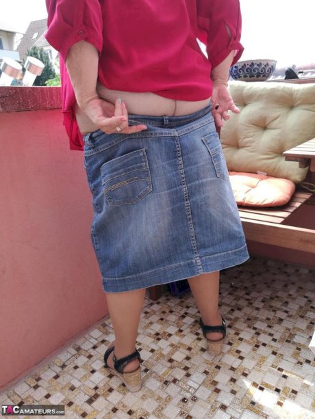 Horny oma spreads her upskirt pussy after pulling down her hose on patio
