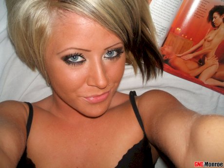 Blonde girl with striking eyes covers her naked body in chocolate sauce
