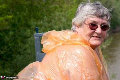 Obese oma Grandma Libby doffs a see-through raincoat to get naked on a bridge