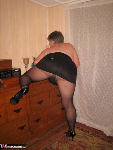Overweight nan Girdle Goddess strips to her footwear in front of a dresser