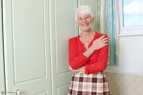 Over 70 Bristish granny takes off her clothes and lingerie striptease style