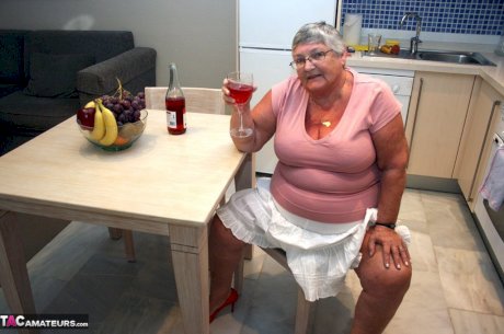 Mature BBW Grandma Libby strips in the kitchen to wine & dine & toy pussy nude