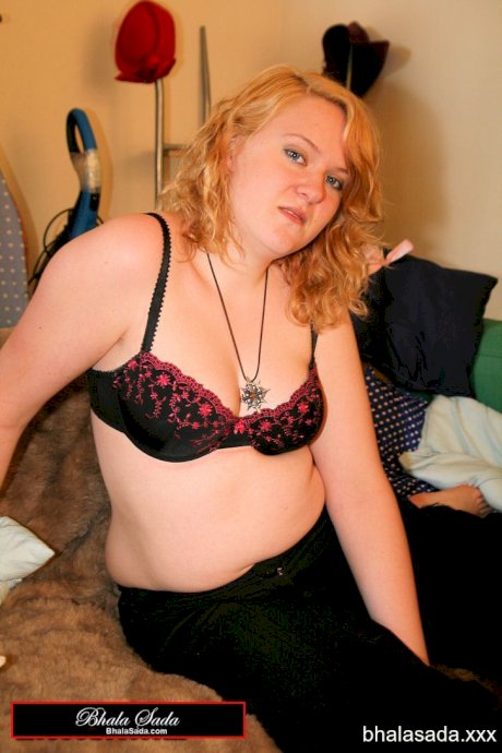 Redheaded fatty strips her sweatshirt and shows her cleavage in a black bra