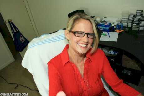 Fully clothed mature blonde in glasses gives a handjob and gets bukkaked