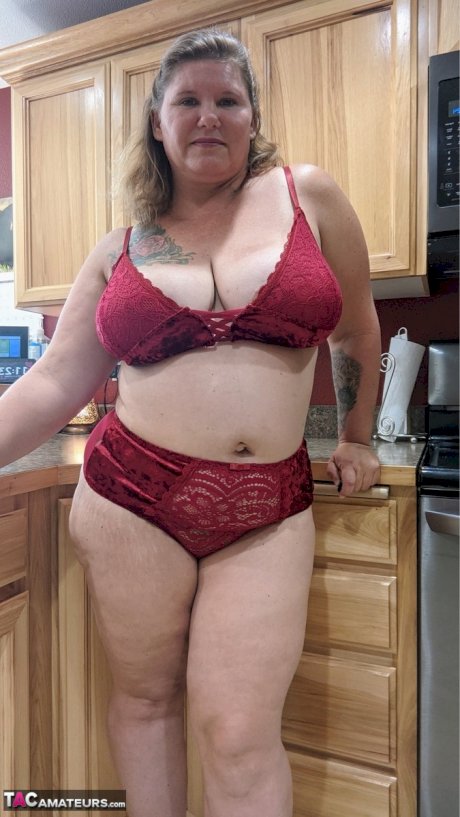 Amateur woman Busty Kris Ann shows her big tits and butt in her kitchen
