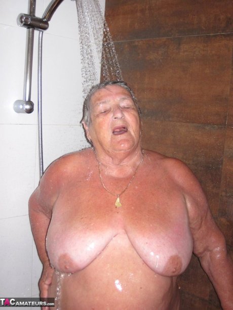 Obese amateur Grandma Libby blow drys her hair after taking a shower