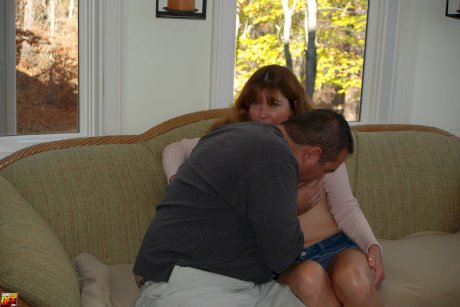 Redheaded MILF with nice boobs eats a dong before getting banged from behind