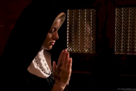 Naughty nun Charlotte Stokely shows small tits for solo candlelit masturbation