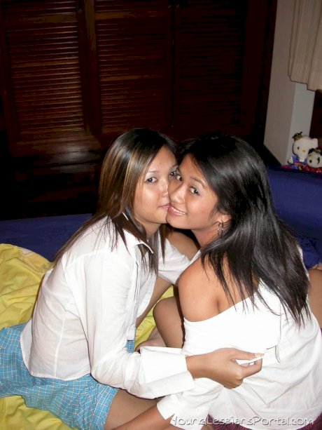 Young Asian girls undress before lesbian sex commences on a bed