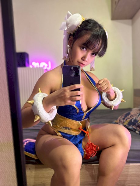 Brunette only fans babe Asian Eye teases with her big cleavage in a hot outfit