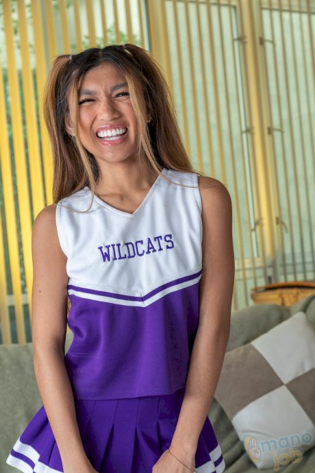 Asian cheerleader Clara Trinity discards her uniform before riding a cock