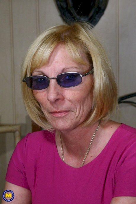 Mature nympho with sunglasses Karin V strips to her sexy high leather boots