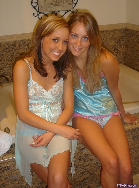 Sexy lesbian teens kiss passionately while showing off their sweet tits