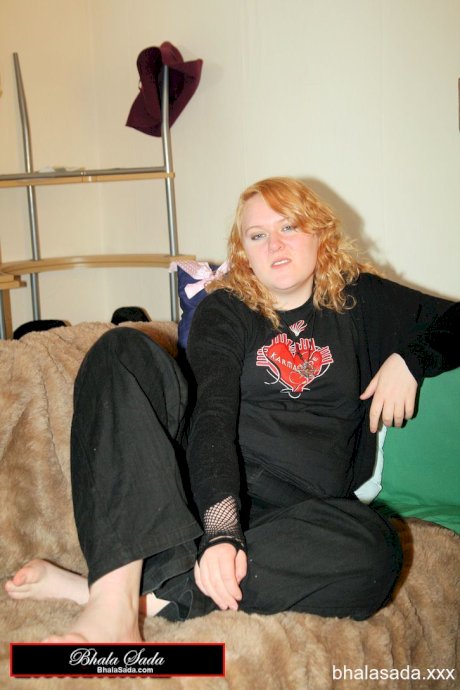 Redheaded fatty strips her sweatshirt and shows her cleavage in a black bra