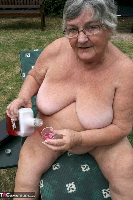 Naughty amateur granny Libby inserting a bottle in her fat pussy in the garden