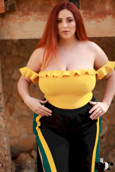 Redheaded fatty Lucy Vixen strips outdoors and shows off her big boobs