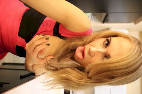 Blonde amateur fondles her tits before showing her Brazilian butt in garters