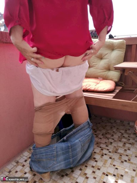 Horny oma spreads her upskirt pussy after pulling down her hose on patio