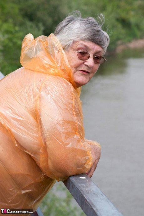Obese oma Grandma Libby doffs a see-through raincoat to get naked on a bridge