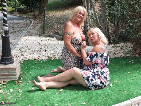 Mature woman Melody and her lesbian lover fondle each others boobs outdoors