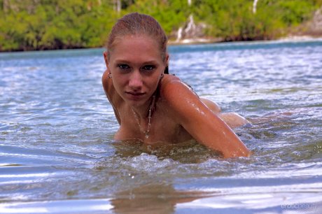 Young beauty Angeli highlights her perfect ass while kneeling in the water