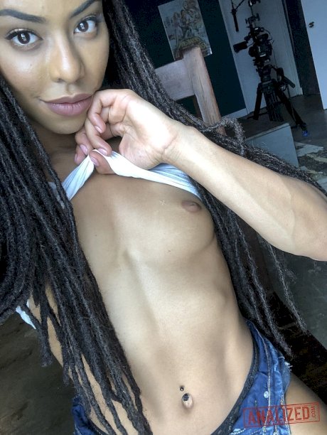 Ebony with dreads Kira Noir unveils her tiny tits and sweet ass in a solo