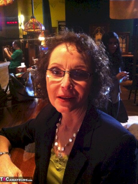 Curly haired mature woman likes sending her younger partner provocative photos