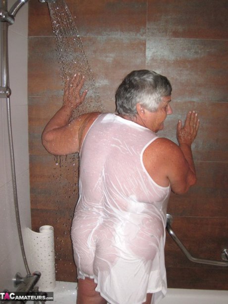 Obese amateur Grandma Libby blow drys her hair after taking a shower